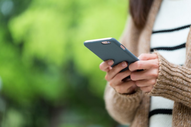 17059859-woman-play-game-on-cellphone