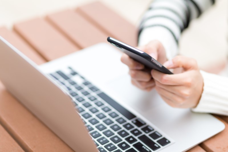 17059882-woman-use-of-laptop-computer-and-cellphone.jpg