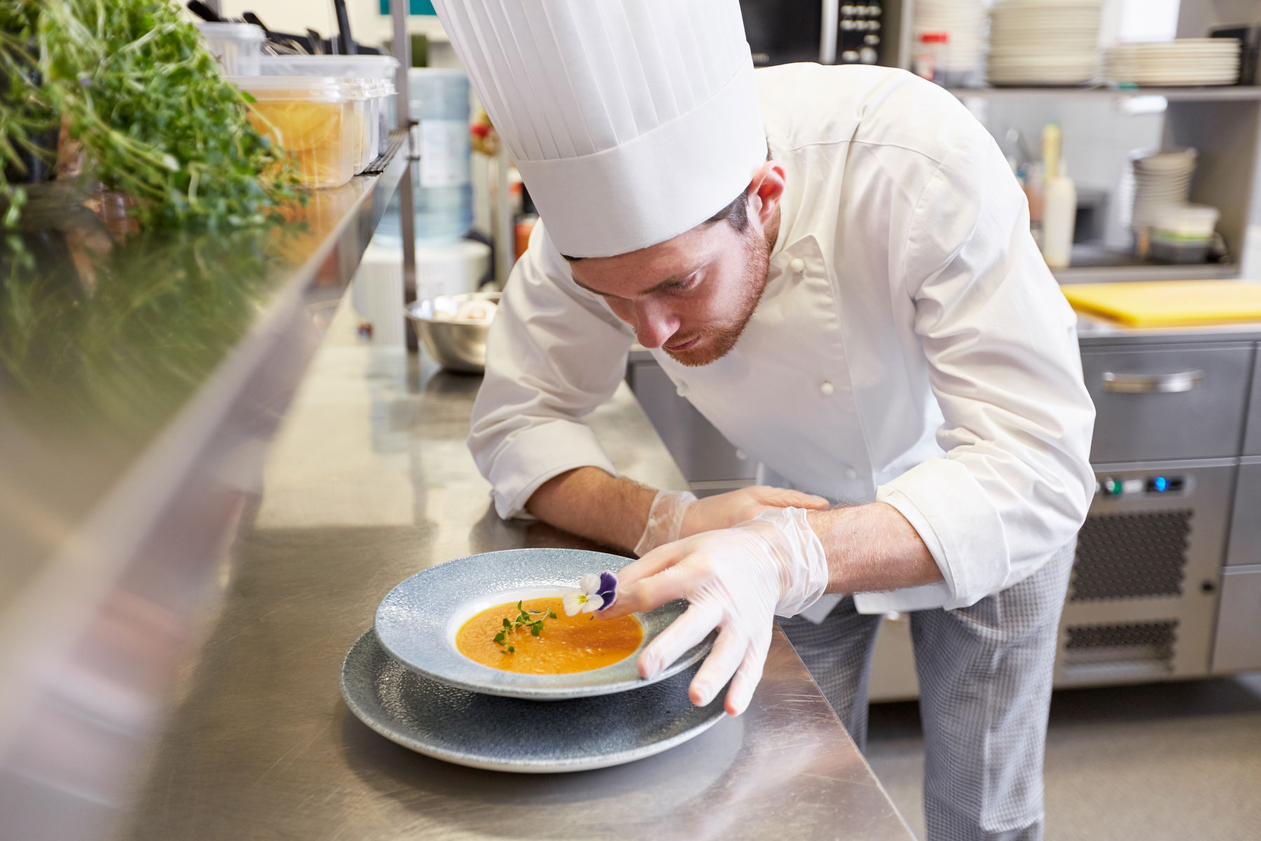 23175223-happy-male-chef-cooking-food-at-restaurant-kitchen.jpg