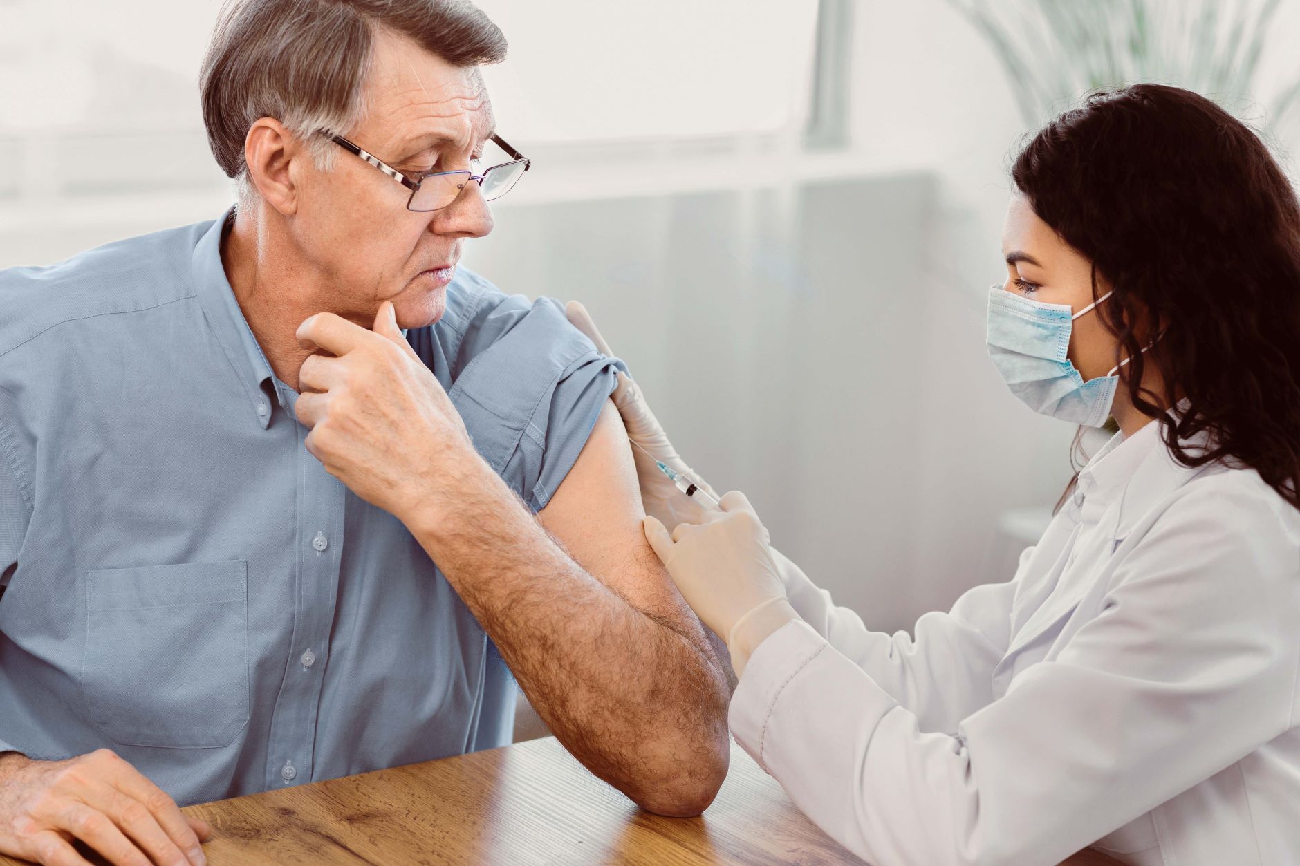 doctor-doing-vaccination-to-elderly-man1.jpg